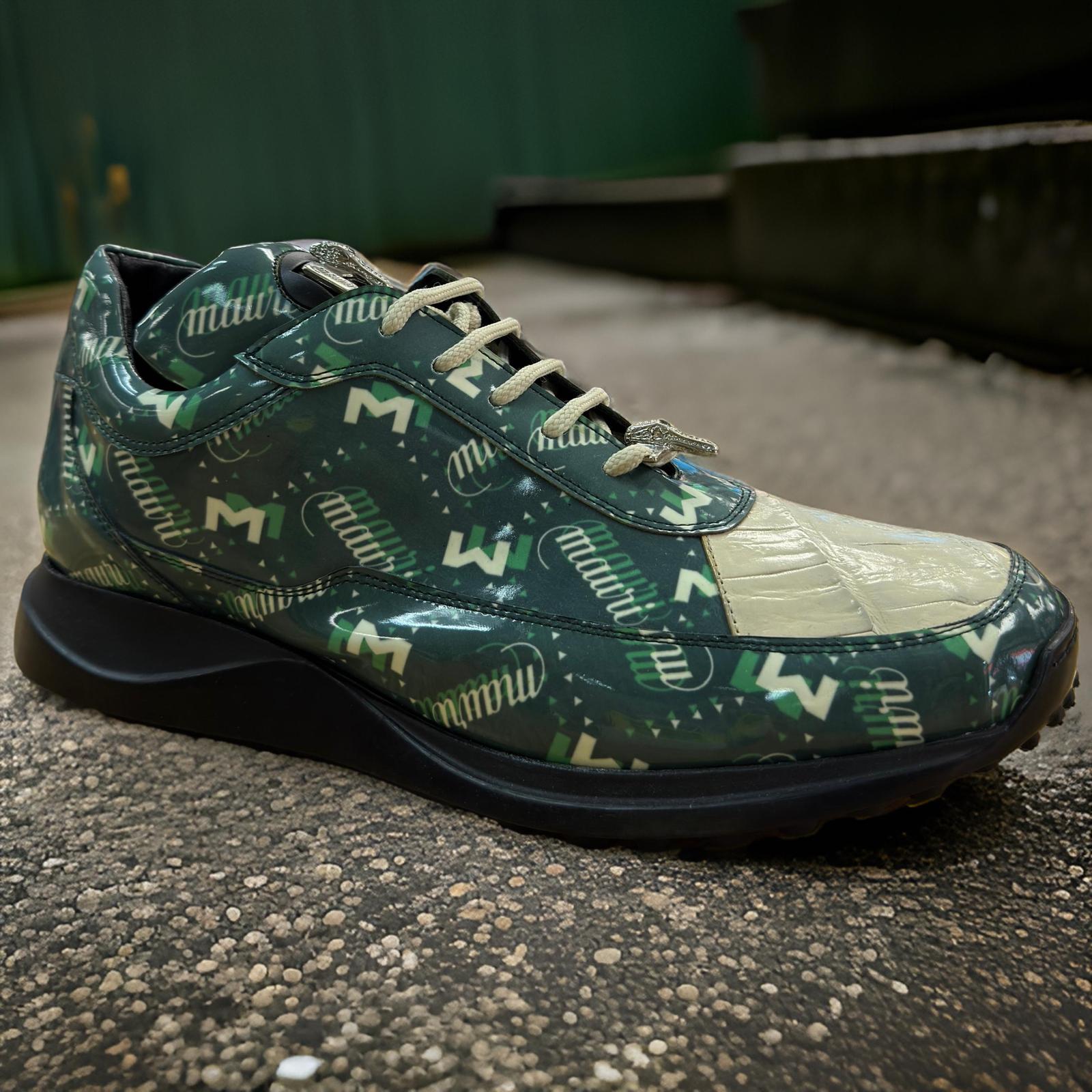 Introducing the Mauri 8900 Green/Tan Shoes, expertly crafted by Mauri. These custom sneakers showcase a unique patterned design in green and beige, adorned with distinctive white "MW" logos. The shoes feature patent leather accents, laces, and a dark sole that exudes style. Set against a textured ground with a complementary green background, these sneakers highlight their standout appeal.