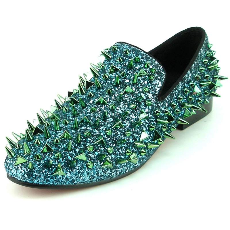 The FI-7239 from Fiesso by Aurelio Garcia showcases fashion-forward shoes featuring blue glitter loafers with a suede upper. They are adorned with striking green and gold spikes, all set on a sleek black sole.