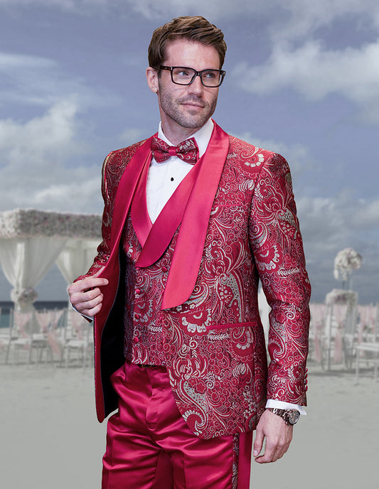 A man, dressed in an Inserch STATEMENT DELANO RED Suit, stands outdoors. He is wearing glasses, a bow tie, and a watch.