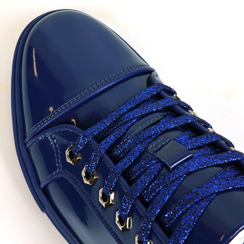 The image highlights the sole of the FI-2415-2 Navy Patent Lace-up Low Cut Leather Sneaker by Fiesso, displaying a red, textured pattern enhanced by a sleek blue trim. Renowned for their comfort and style, these sneakers also exude elegance with patent leather accents.