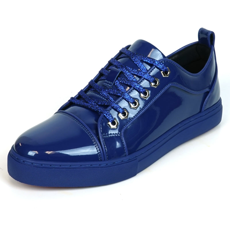 The image highlights the sole of the FI-2415-2 Navy Patent Lace-up Low Cut Leather Sneaker by Fiesso, displaying a red, textured pattern enhanced by a sleek blue trim. Renowned for their comfort and style, these sneakers also exude elegance with patent leather accents.