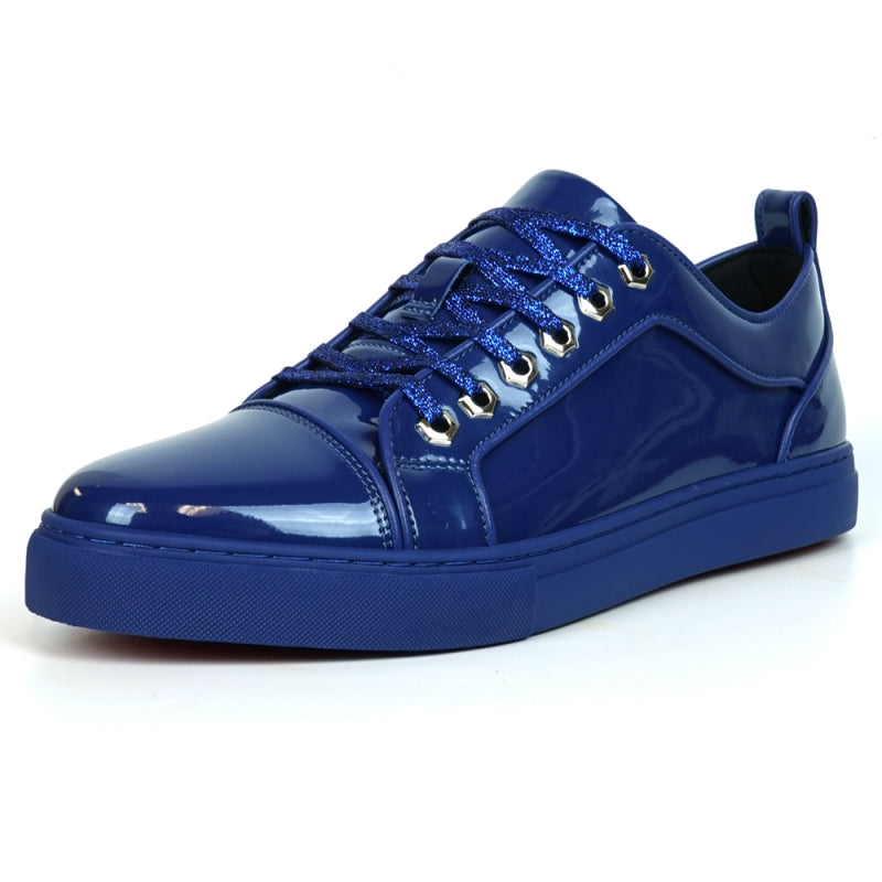 The image highlights the sole of the FI-2415-2 Navy Patent Lace-up Low Cut Leather Sneaker by Fiesso, displaying a red, textured pattern enhanced by a sleek blue trim. Renowned for their comfort and style, these sneakers also exude elegance with patent leather accents.