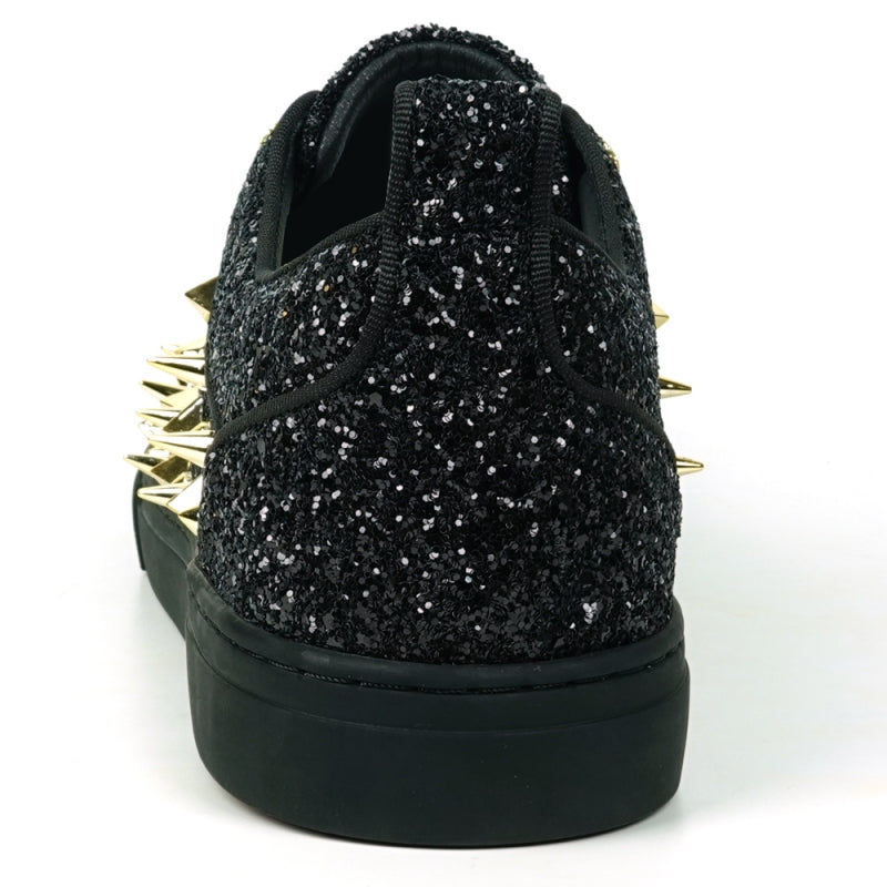 Featuring a striking close-up of the FI-2429 Black Glitter Gold Spikes Low Cut Sneaker Encore by Fiesso, this bold design highlights the shoe's black glitter surface complemented by gold spikes and laces. Embodying Fiesso's signature elegance, this high-fashion men's sneaker shines brilliantly, transforming each stride into a statement of style.