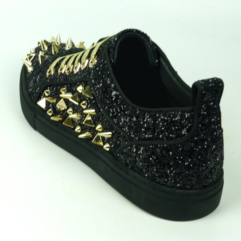 Featuring a striking close-up of the FI-2429 Black Glitter Gold Spikes Low Cut Sneaker Encore by Fiesso, this bold design highlights the shoe's black glitter surface complemented by gold spikes and laces. Embodying Fiesso's signature elegance, this high-fashion men's sneaker shines brilliantly, transforming each stride into a statement of style.