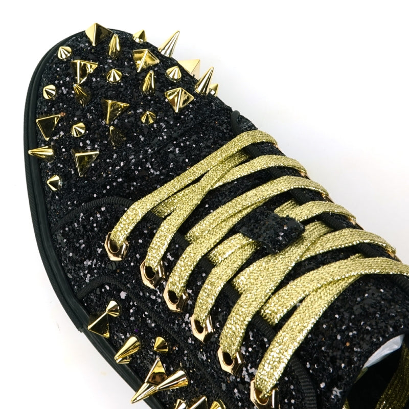 Featuring a striking close-up of the FI-2429 Black Glitter Gold Spikes Low Cut Sneaker Encore by Fiesso, this bold design highlights the shoe's black glitter surface complemented by gold spikes and laces. Embodying Fiesso's signature elegance, this high-fashion men's sneaker shines brilliantly, transforming each stride into a statement of style.