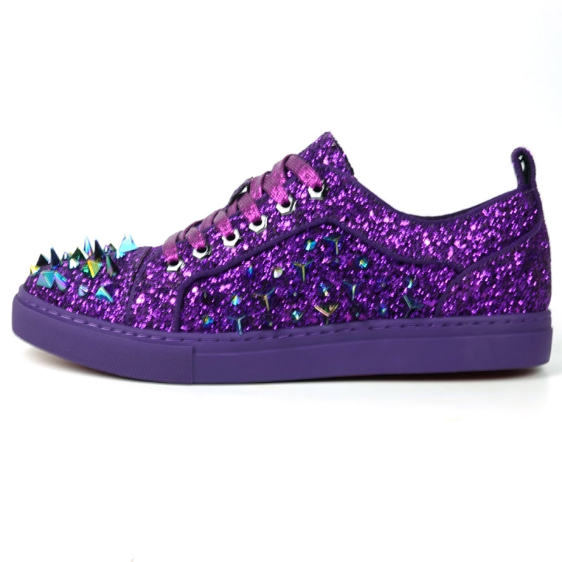 Close-up of the Encore by Fiesso, FI-2429 low-cut sneaker, showcasing a high-fashion design with purple glitter and spikes, complemented by multicolored triangular metal accents and purple laces.