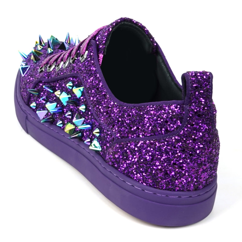 Close-up of the Encore by Fiesso, FI-2429 low-cut sneaker, showcasing a high-fashion design with purple glitter and spikes, complemented by multicolored triangular metal accents and purple laces.