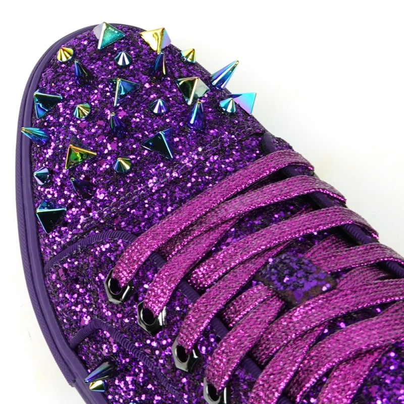 Close-up of the Encore by Fiesso, FI-2429 low-cut sneaker, showcasing a high-fashion design with purple glitter and spikes, complemented by multicolored triangular metal accents and purple laces.