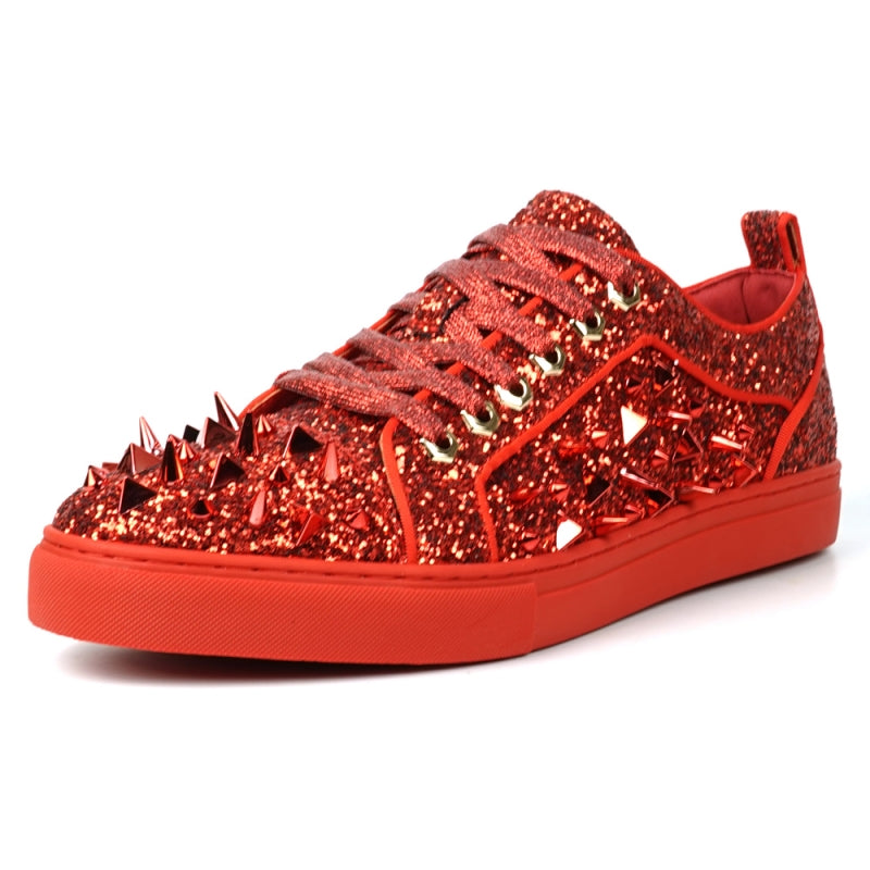 A close-up of the FI-2429 Red Glitter Red Spikes Low Cut Sneaker Encore by Fiesso showcases its dazzling red glitter, bold metal spikes, and matching shoelaces.