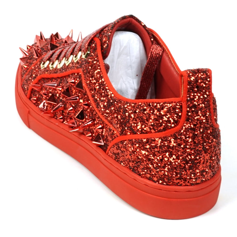 A close-up of the FI-2429 Red Glitter Red Spikes Low Cut Sneaker Encore by Fiesso showcases its dazzling red glitter, bold metal spikes, and matching shoelaces.