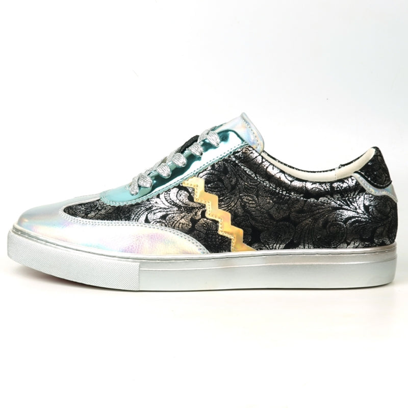 Step up your style with the FI-2431 Silver Multi Lace-Up Low Cut Sneaker Encore by Fiesso, showcasing a dynamic design that includes shiny turquoise and silver sections, glittery silver laces, intricate black lace-like patterns, and an eye-catching gold zigzag detail on the side.