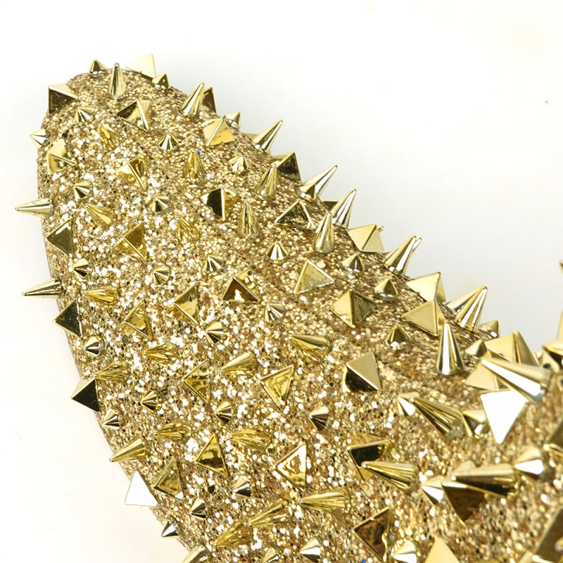 Close-up of the FI-7527 Gold Glitter Gold Spikes Boot Encore by Fiesso, featuring a sparkly gold surface embellished with an array of metallic spikes in different sizes and shapes, capturing the edgy elegance typical of high fashion sneakers against a plain background.