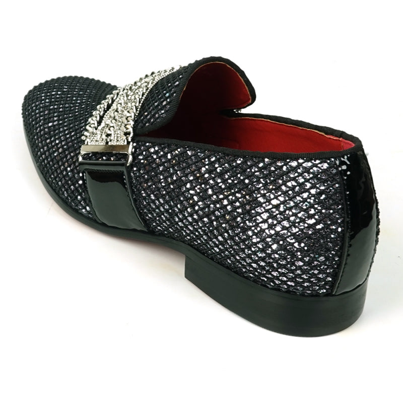 The Fiesso FI-7528 Black Silver Slip-On Loafer is a sophisticated men's dress shoe, featuring a textured leather exterior with a shiny finish. It is elegantly adorned with silver chains across the top and boasts a striking red interior lining, making it the perfect blend of modern style and elegance.