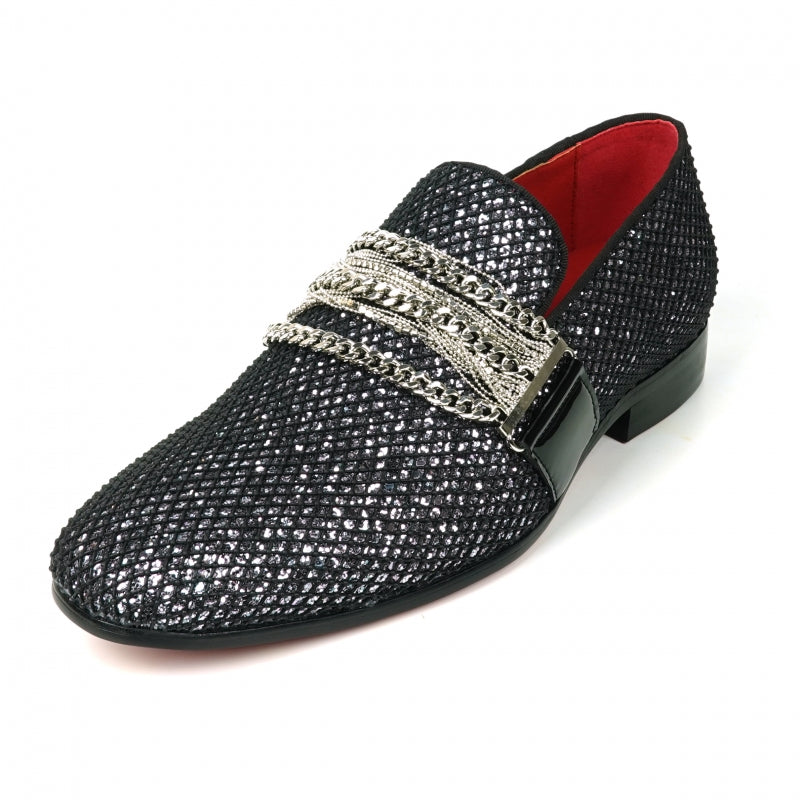 The Fiesso FI-7528 Black Silver Slip-On Loafer is a sophisticated men's dress shoe, featuring a textured leather exterior with a shiny finish. It is elegantly adorned with silver chains across the top and boasts a striking red interior lining, making it the perfect blend of modern style and elegance.