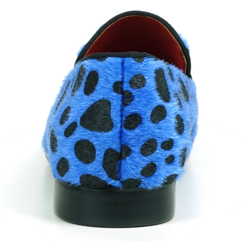 A slip-on loafer featuring a blue and black leopard print design with a pony hair texture, capturing the stylish essence of Fiesso by Aurelio Garcia when admired from the front.