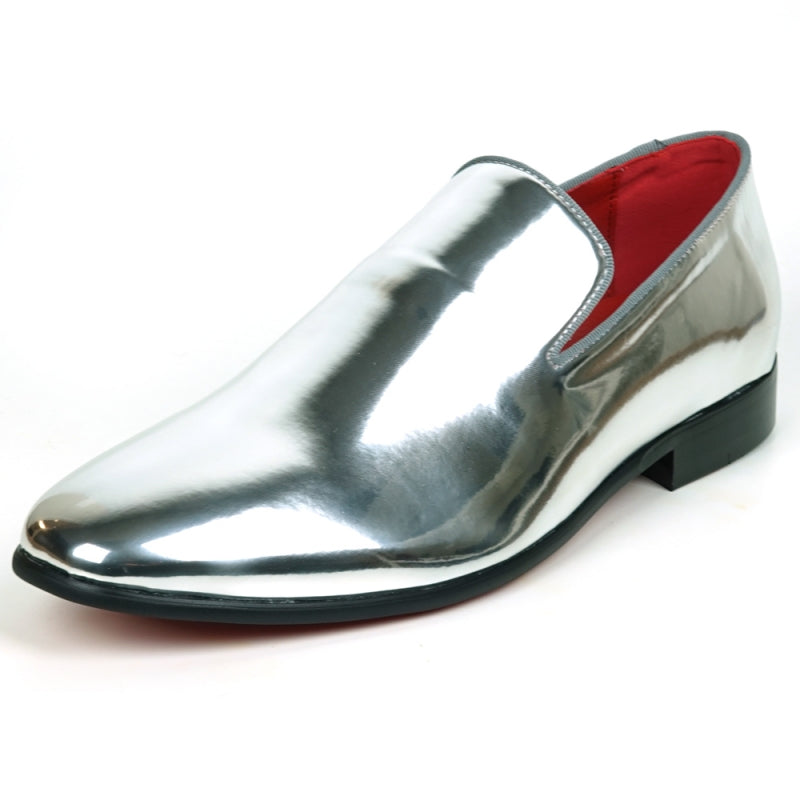 The FI-7548 Silver Patent Slip On Leafer by Fiesso embodies the sophistication of men's dress shoes with its sleek, shiny silver exterior and vibrant red interior complemented by a sturdy black sole. This elegant design seamlessly integrates the allure of vegan leather, offering both style and comfort with every step.