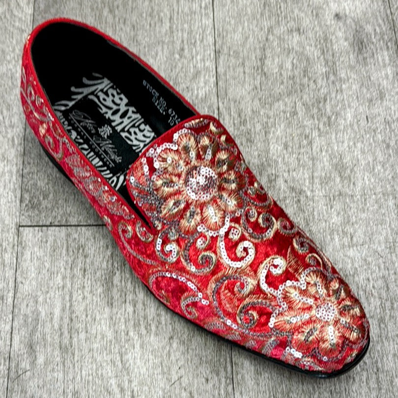 The Exclusive Formal Dress Shoe in Red / Gold 6734 by UNIQUE DESIGN MENSWEAR showcases genuine leather in a slip-on style, adorned with intricate gold and silver floral embroidery and sequins, elegantly highlighted on a wooden floor.