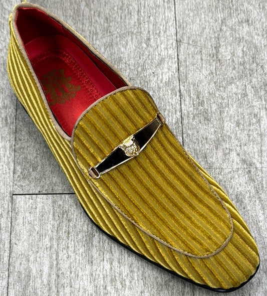 The product "Exclusive Formal Dress Shoe Yellow 6946" by UNIQUE DESIGN MENSWEAR features a gold velvet slipper with vertical stripes, a red interior, and a metal embellishment on top, expertly crafted from genuine suede leather sourced from Italy, displayed on a gray textured surface.