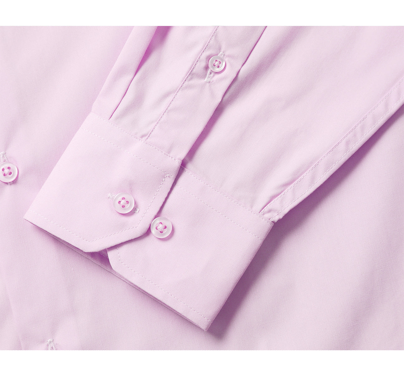 The folded VERNO Light Pink Classic Fit Long Sleeve Travel Easy-Care Cotton Dress Shirt by Renoir features a pointed collar and buttoned cuffs. Made from 100% cotton, the fabric close-up reveals its smooth, fine texture that is also wrinkle-resistant.