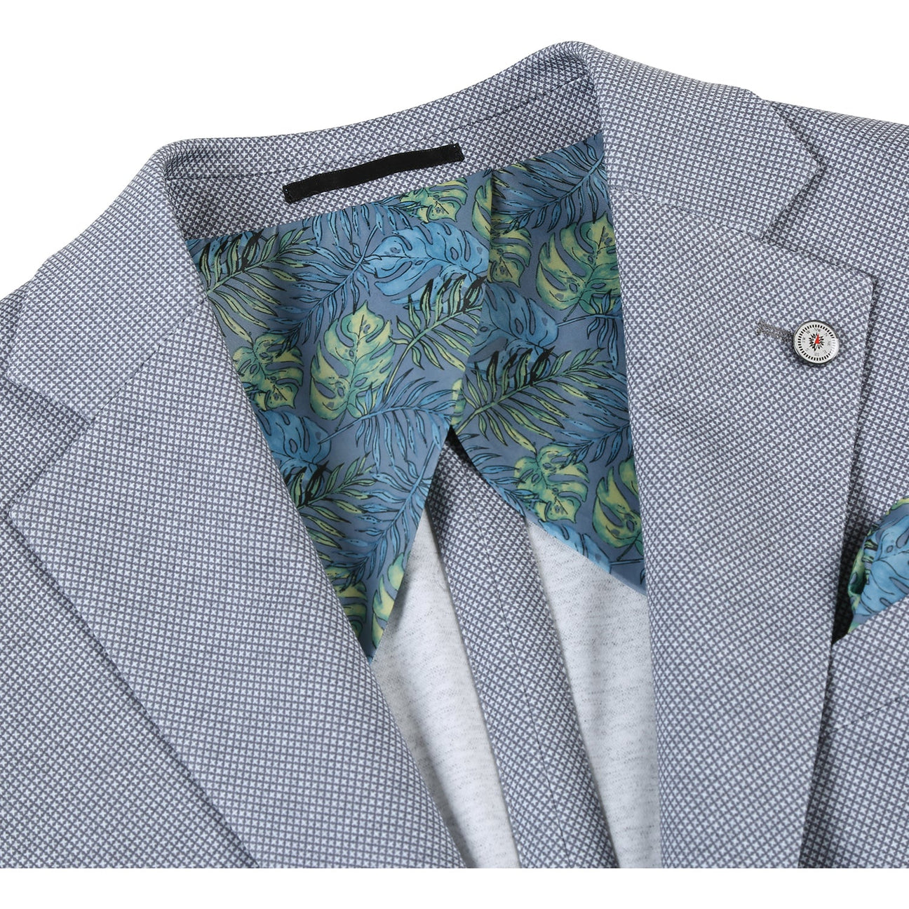 Introducing the Pellagio Gray Men's Half Canvas Blazer PS23-1: This elegant blazer by Pellagio features a sophisticated subtle texture in gray, accented by a floral-patterned lining and coordinating pocket square. It is designed with a notched lapel, two-button closure, two spacious front pockets, and includes a stylish lapel pin for an extra touch of flair.