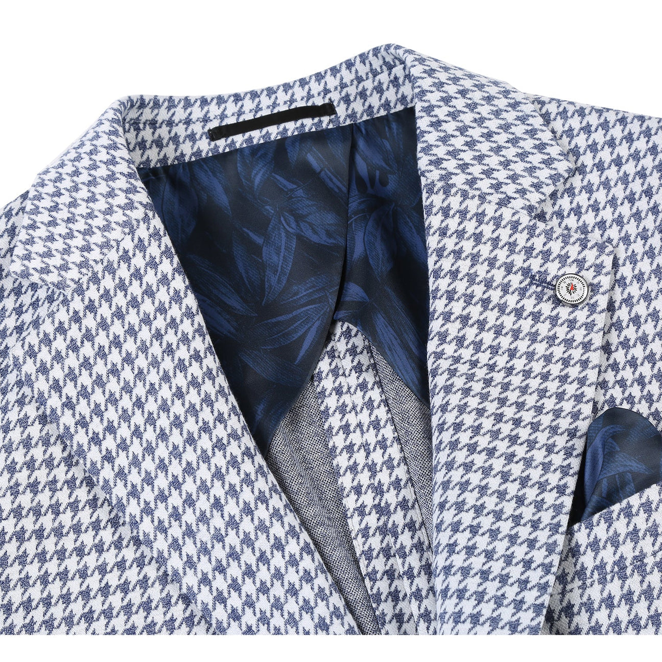 A mannequin showcasing the Pellagio Blue Houndstooth Men's Half Canvas Blazer PS23-5 features a notched lapel, complemented by a white shirt, blue tie, and a blue pocket square. The slim-fit design of this Pellagio blazer brings a modern flair to the classic ensemble.