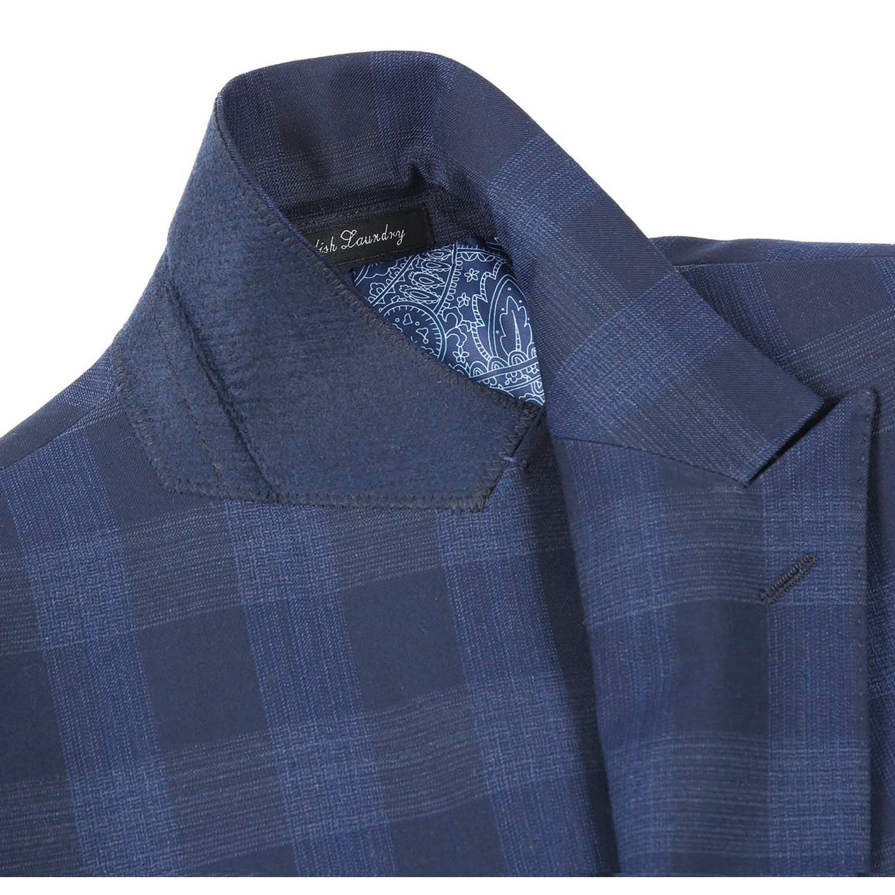 The ENGLISH LAUNDRY Navy Wool Suit EL82-65-410 by English Laundry features a navy plaid slim fit jacket with peak lapels and two buttons, crafted from a wool polyester blend, displayed on a mannequin with a white dress shirt and an orange patterned tie.