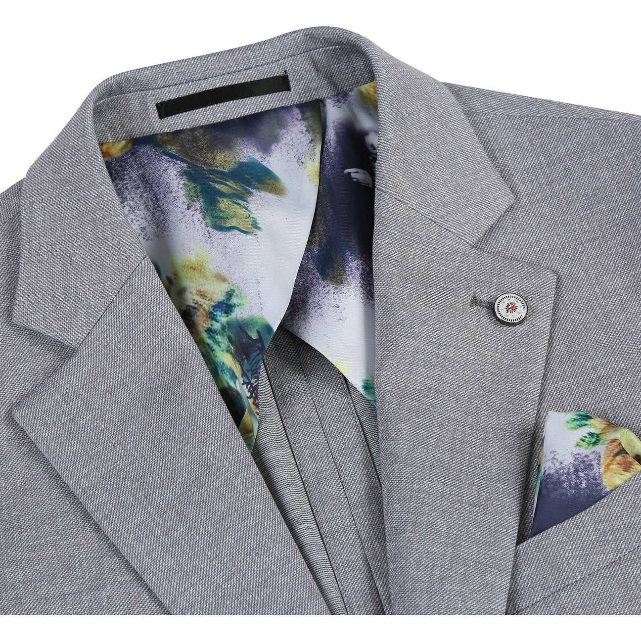 The Pellagio Riserva JKT Sports Coat PS24-2 is a gray blazer by Pellagio, featuring tropical print lining, button details, and a fabric swatch. It is crafted from a blend of 86% polyester, 9% rayon, and 5% spandex for both comfort and style.