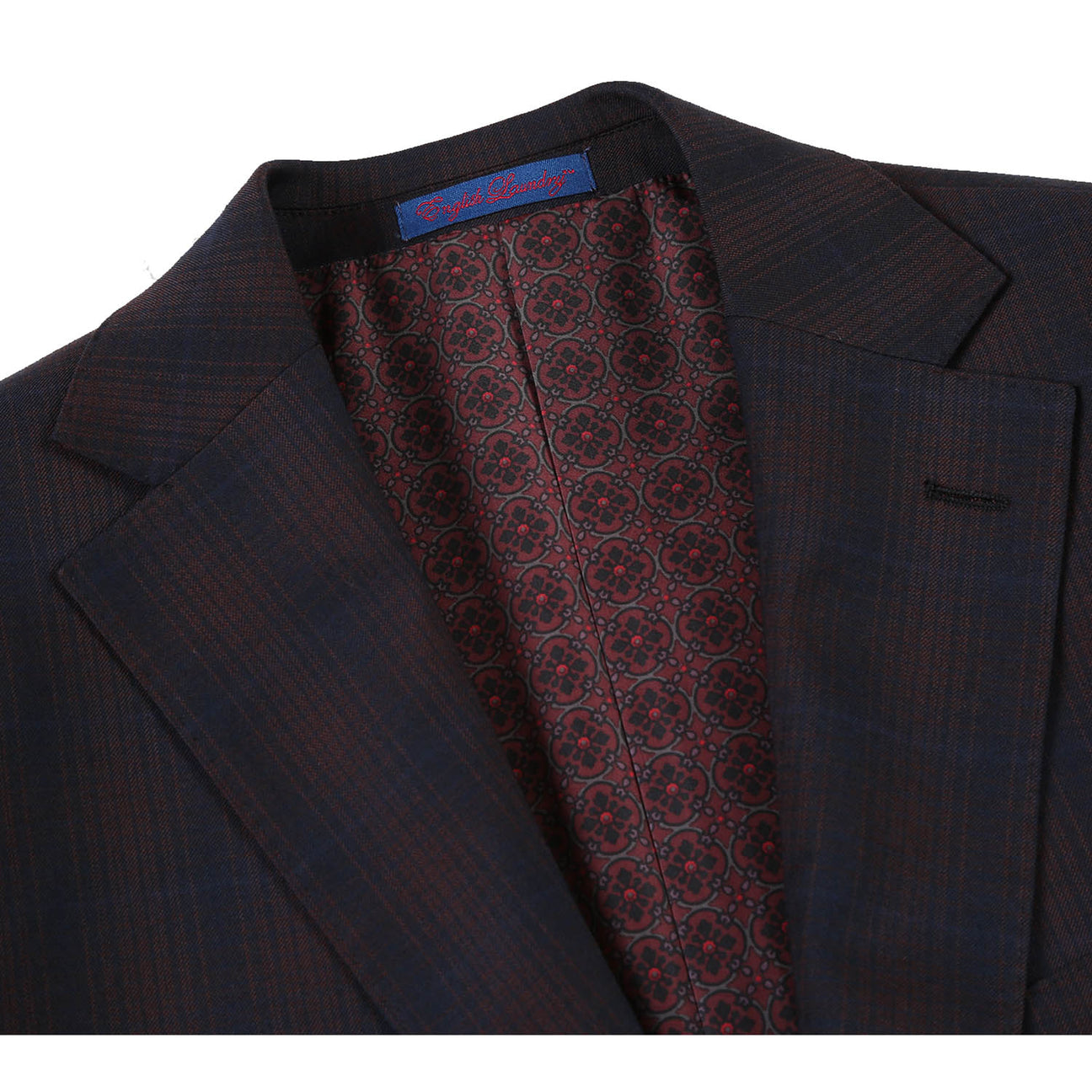 The English Laundry Coffee with Red Check Suit 82-56-410EL, a slim fit jacket with notch lapels and a subtle pattern, is elegantly displayed on a mannequin paired with a white shirt and an orange patterned tie.