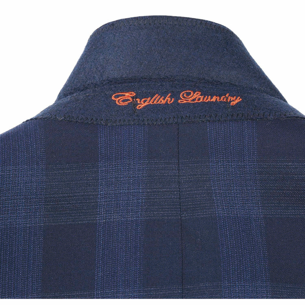 The ENGLISH LAUNDRY Navy Wool Suit EL82-65-410 by English Laundry features a navy plaid slim fit jacket with peak lapels and two buttons, crafted from a wool polyester blend, displayed on a mannequin with a white dress shirt and an orange patterned tie.