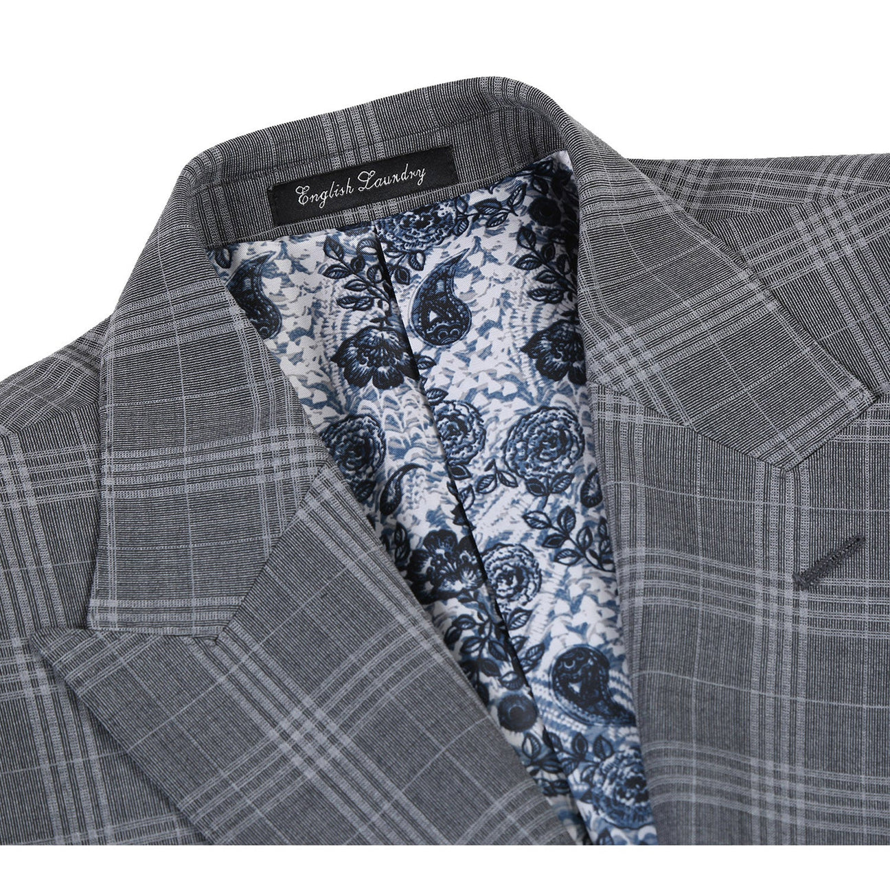 A slim fit jacket from English Laundry, specifically the ENGLISH LAUNDRY Gray Check Peak Wool Suit (EL72-58-093), featuring a peak lapel and two-button closure, elegantly complemented by a white shirt and an orange patterned tie, displayed on a mannequin.