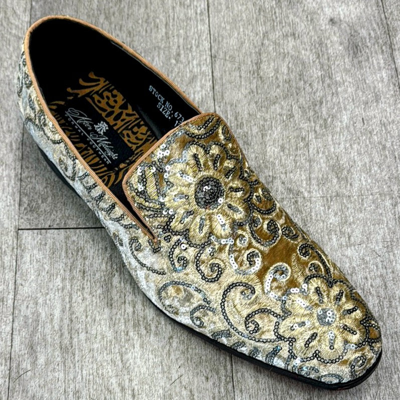 The Exclusive Formal Dress Shoe Yellow / Silver 6734 from UNIQUE DESIGN MENSWEAR, made of genuine leather with intricate floral and swirl patterns enhanced by sequins, is gracefully displayed on a textured gray floor.