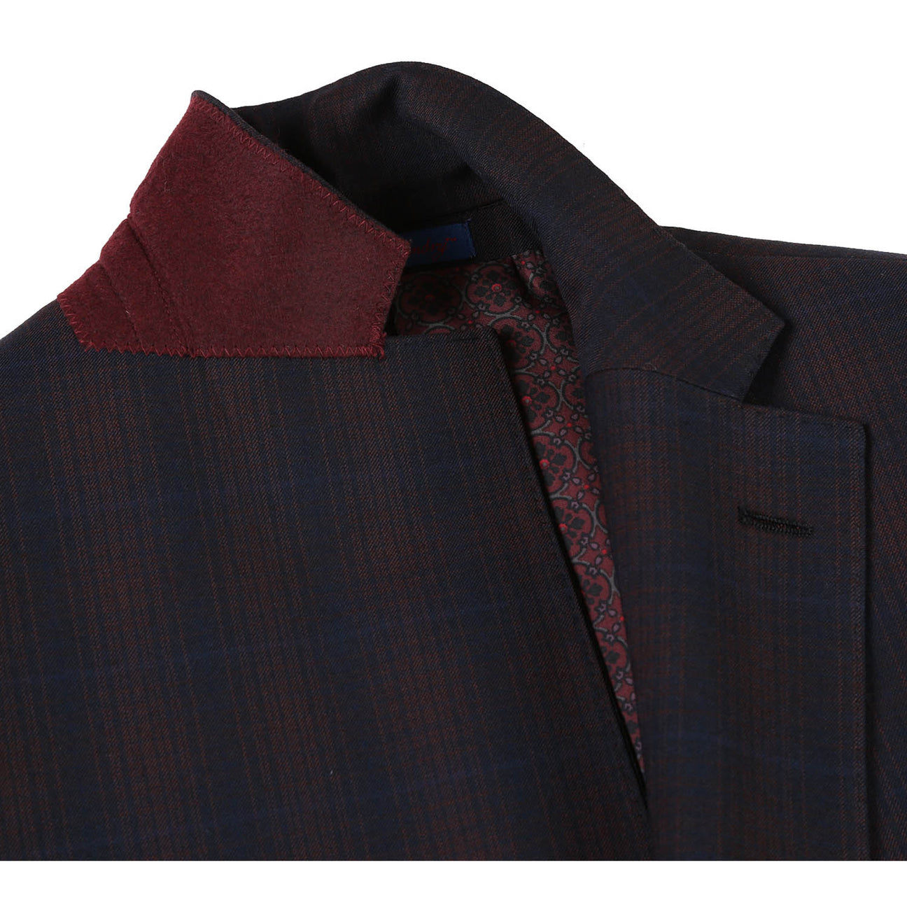 The English Laundry Coffee with Red Check Suit 82-56-410EL, a slim fit jacket with notch lapels and a subtle pattern, is elegantly displayed on a mannequin paired with a white shirt and an orange patterned tie.