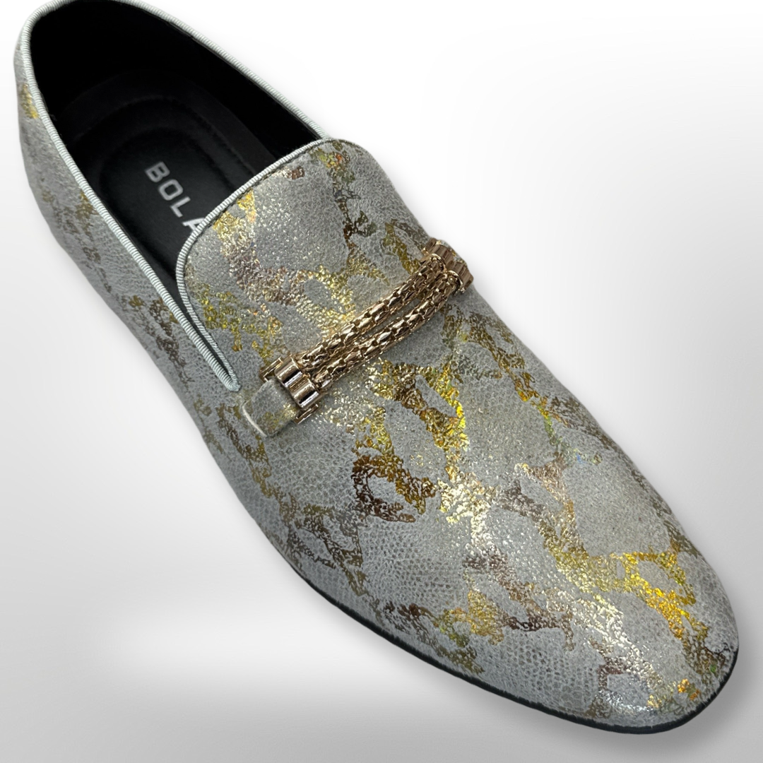 The Fiesso Shoe 79, available only in size 11, showcases a silver and gold abstract design accented by a decorative metal chain and is offered as a final sale item.