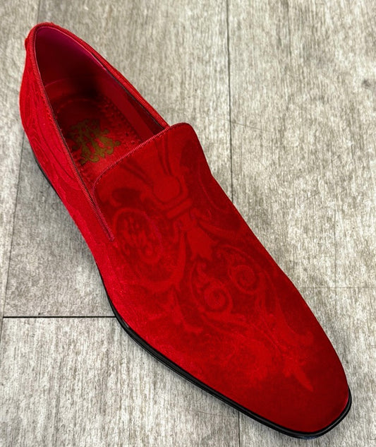 An exclusive red paisley loafer from UNIQUE DESIGN MENSWEAR, crafted from genuine suede leather with a subtle baroque pattern, rests elegantly on a light wooden floor.