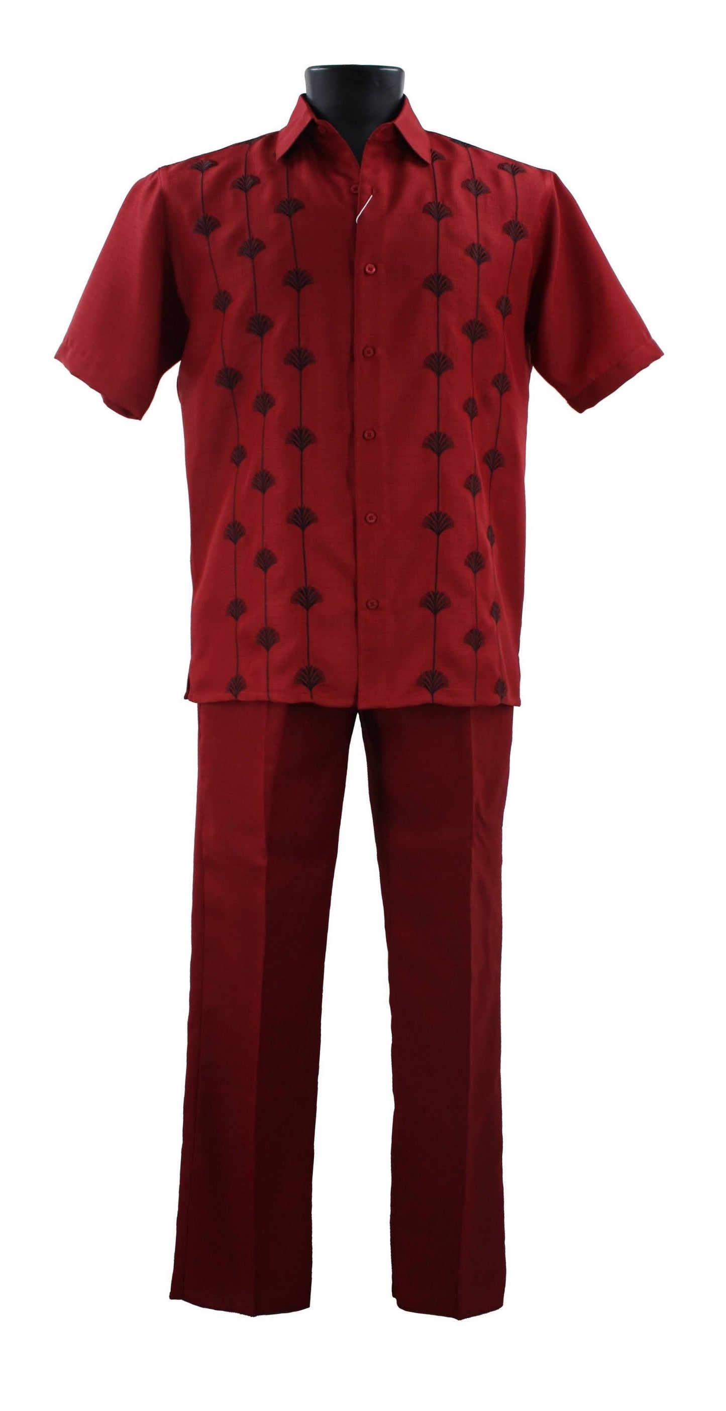 The Bassiri Red 2pc Set A 141 features a red short-sleeve button-up shirt and pants adorned with black vertical leaf patterns, crafted from polyester. Displayed elegantly on a mannequin.