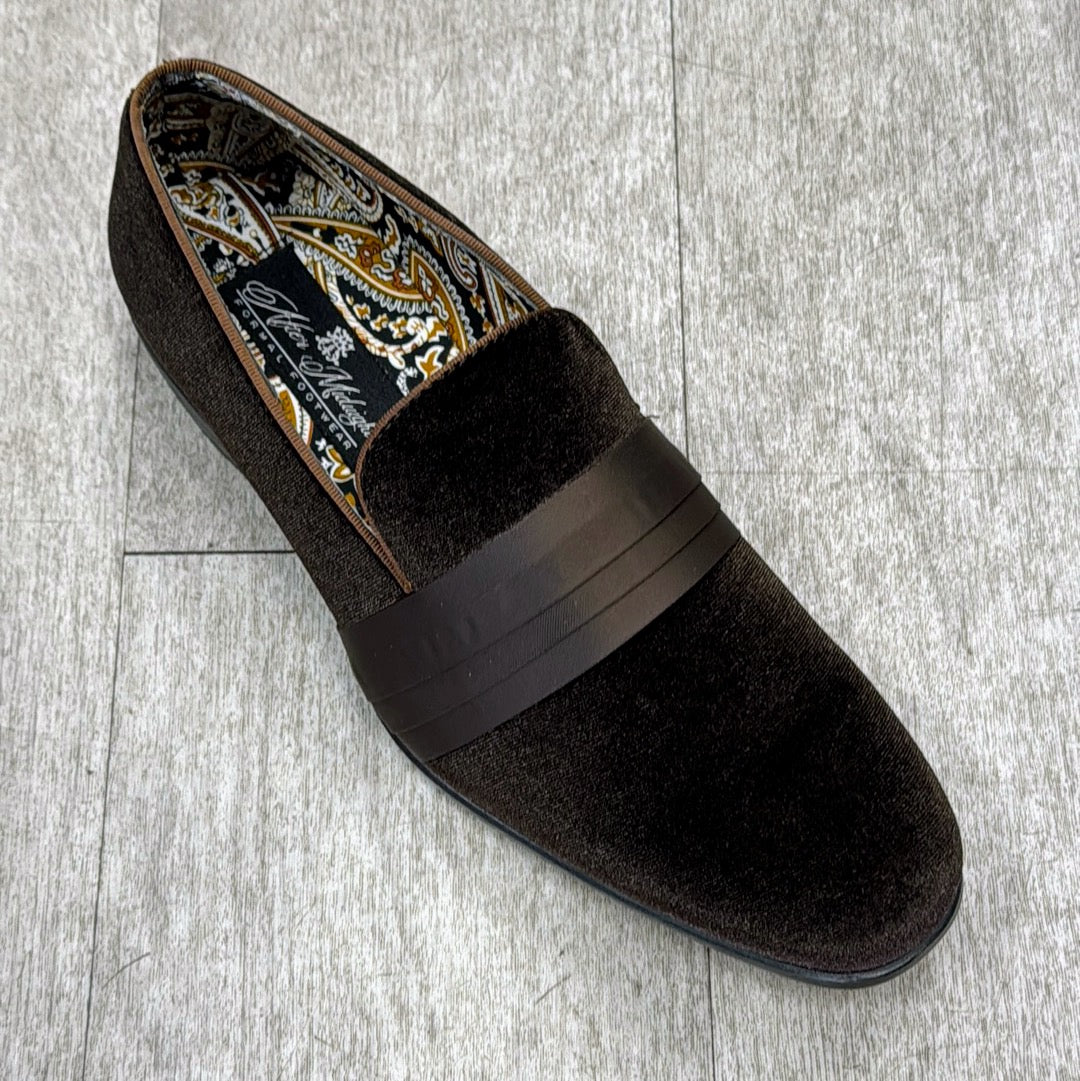 An Exclusive Formal Dress Shoe Brown 7021 by UNIQUE DESIGN MENSWEAR, featuring a textured band and a full genuine leather design, with a paisley-patterned interior, rests gracefully on a gray wood floor.