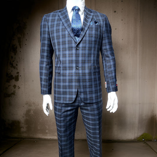 A mannequin showcases the Gianco Ferro Modern Fit Suit in Navy by Unique Design Menswear, featuring a blue plaid pattern with a coordinated vest, shirt, and patterned tie. The ensemble includes flat front pants and a classic notch lapel. The backdrop is a plain wall with a stained texture, enhancing the sophisticated display.