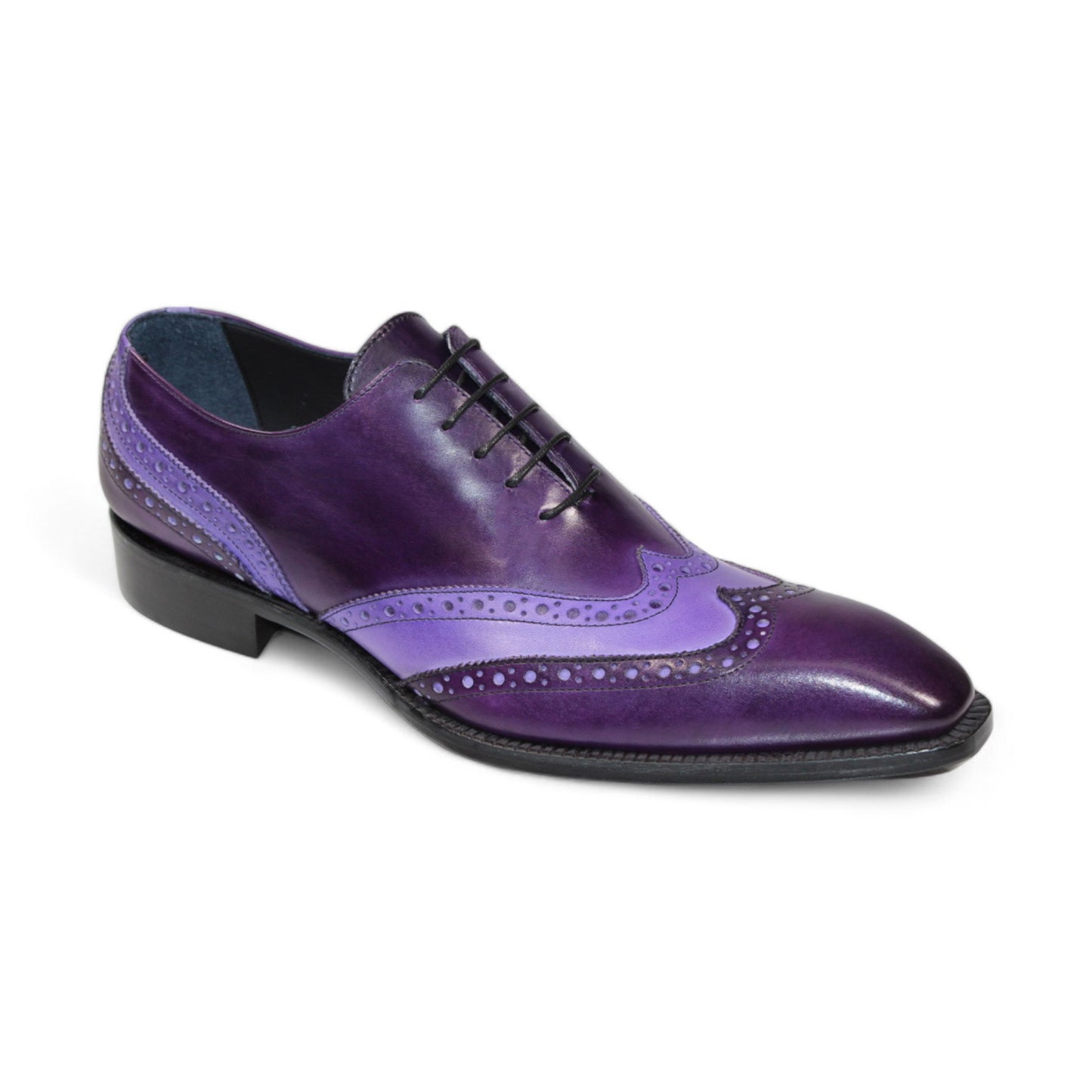 The Duca Di Matiste Andora in purple and lavender exudes a touch of luxury with its decorative perforations, reminiscent of velvet elegance. This leather brogue shoe is complemented by a black sole, creating a sophisticated style statement.