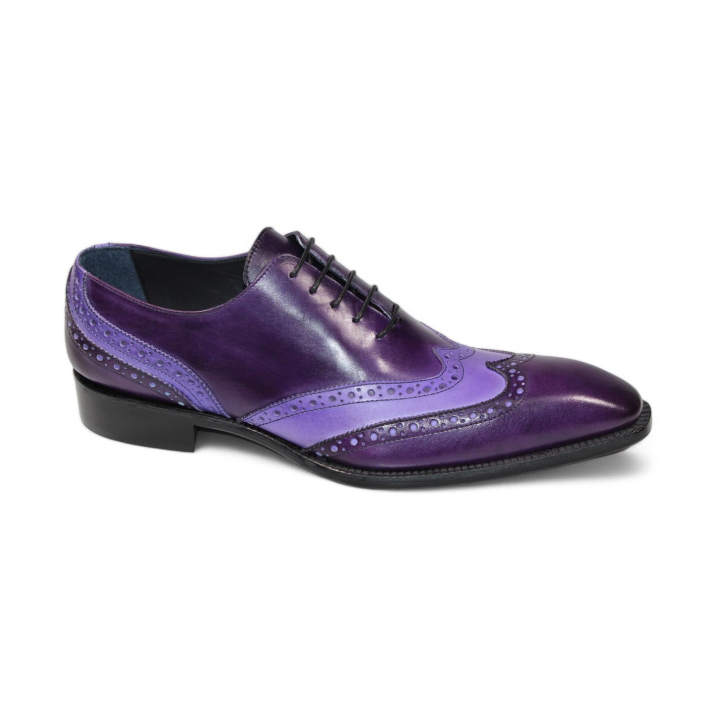 The Duca Di Matiste Andora in purple and lavender exudes a touch of luxury with its decorative perforations, reminiscent of velvet elegance. This leather brogue shoe is complemented by a black sole, creating a sophisticated style statement.