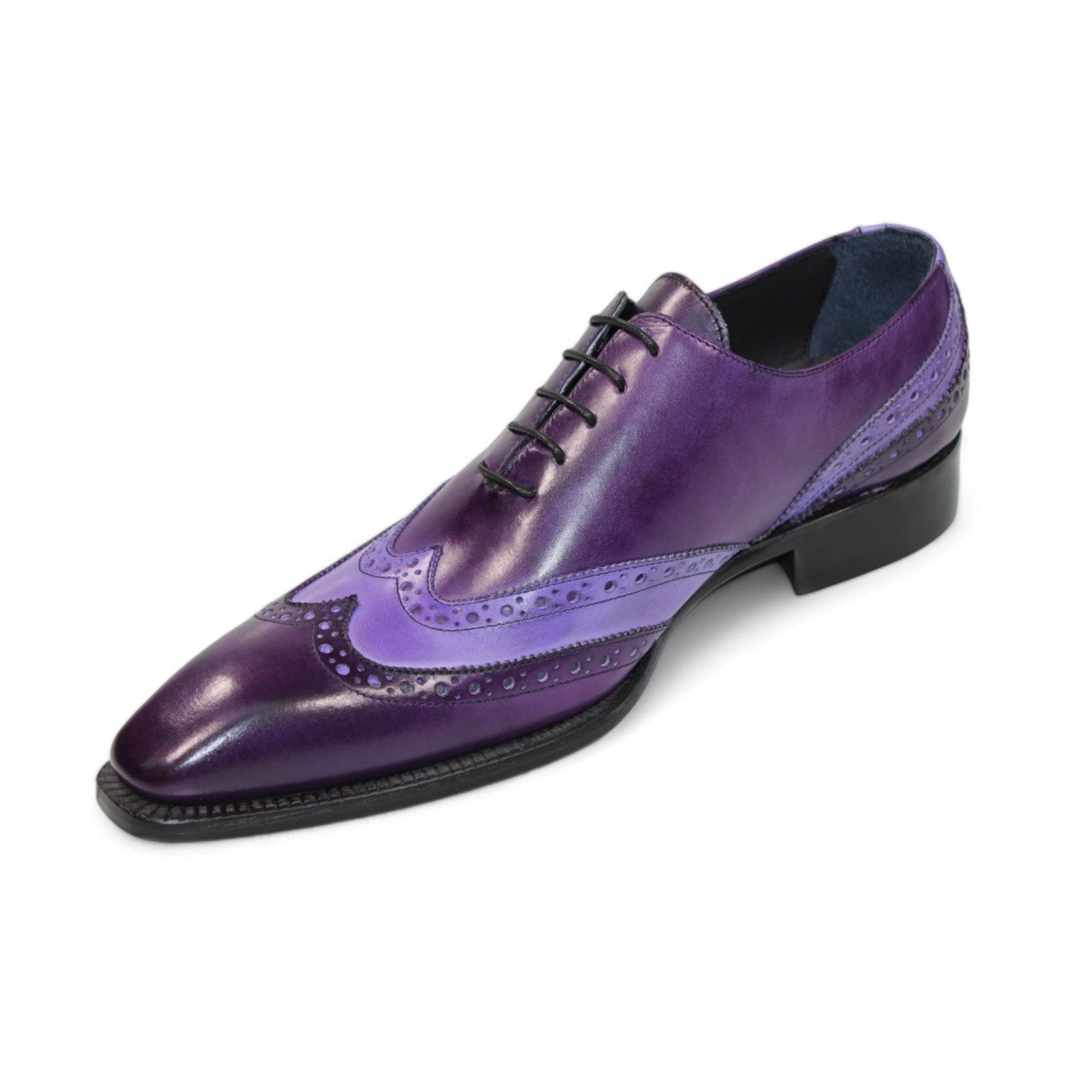 The Duca Di Matiste Andora in purple and lavender exudes a touch of luxury with its decorative perforations, reminiscent of velvet elegance. This leather brogue shoe is complemented by a black sole, creating a sophisticated style statement.