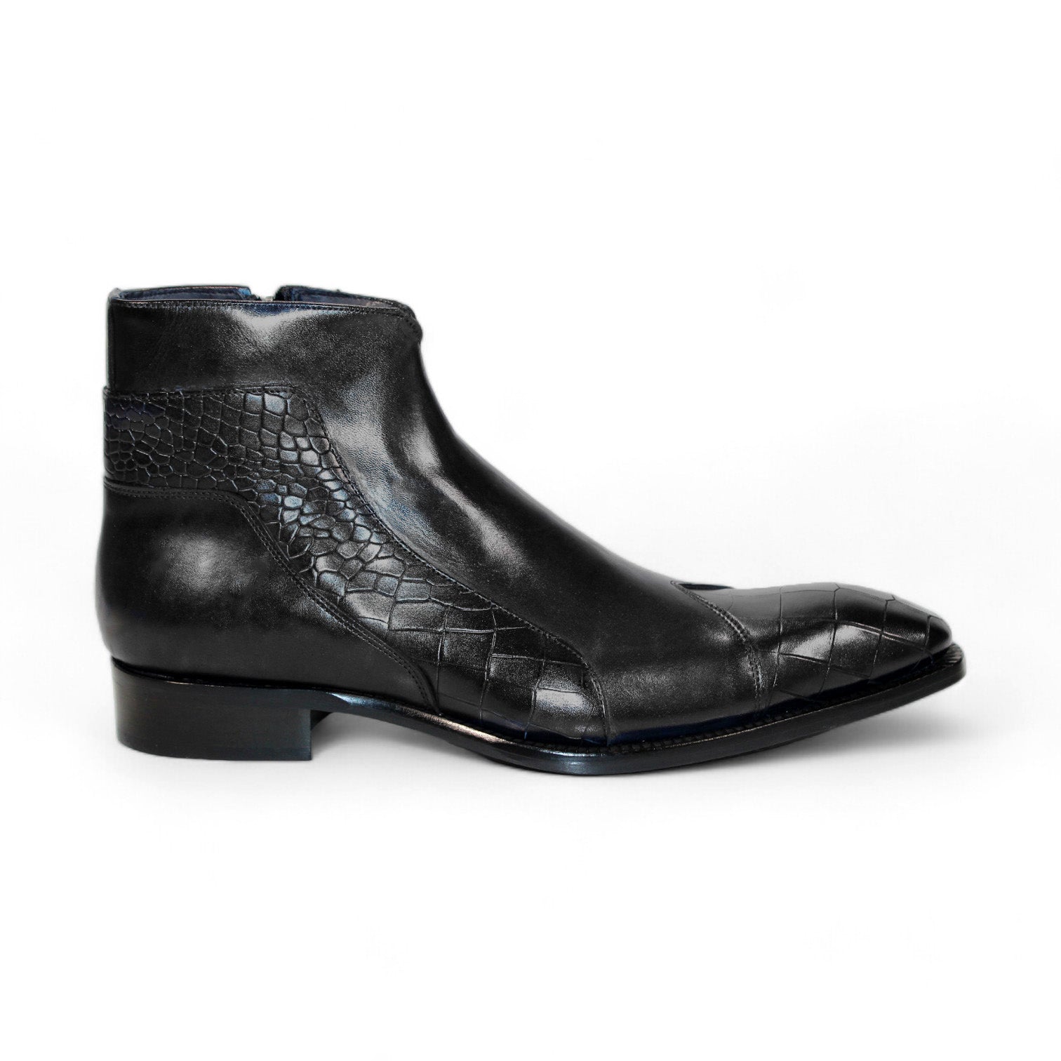 The Duca Di Matiste Aprilia (Black) ankle boot is skillfully crafted from genuine leather, showcasing a distinctive embossed Croco design on the toe and side. With its sleek finish and low heel, this Italian-made footwear embodies elegance.