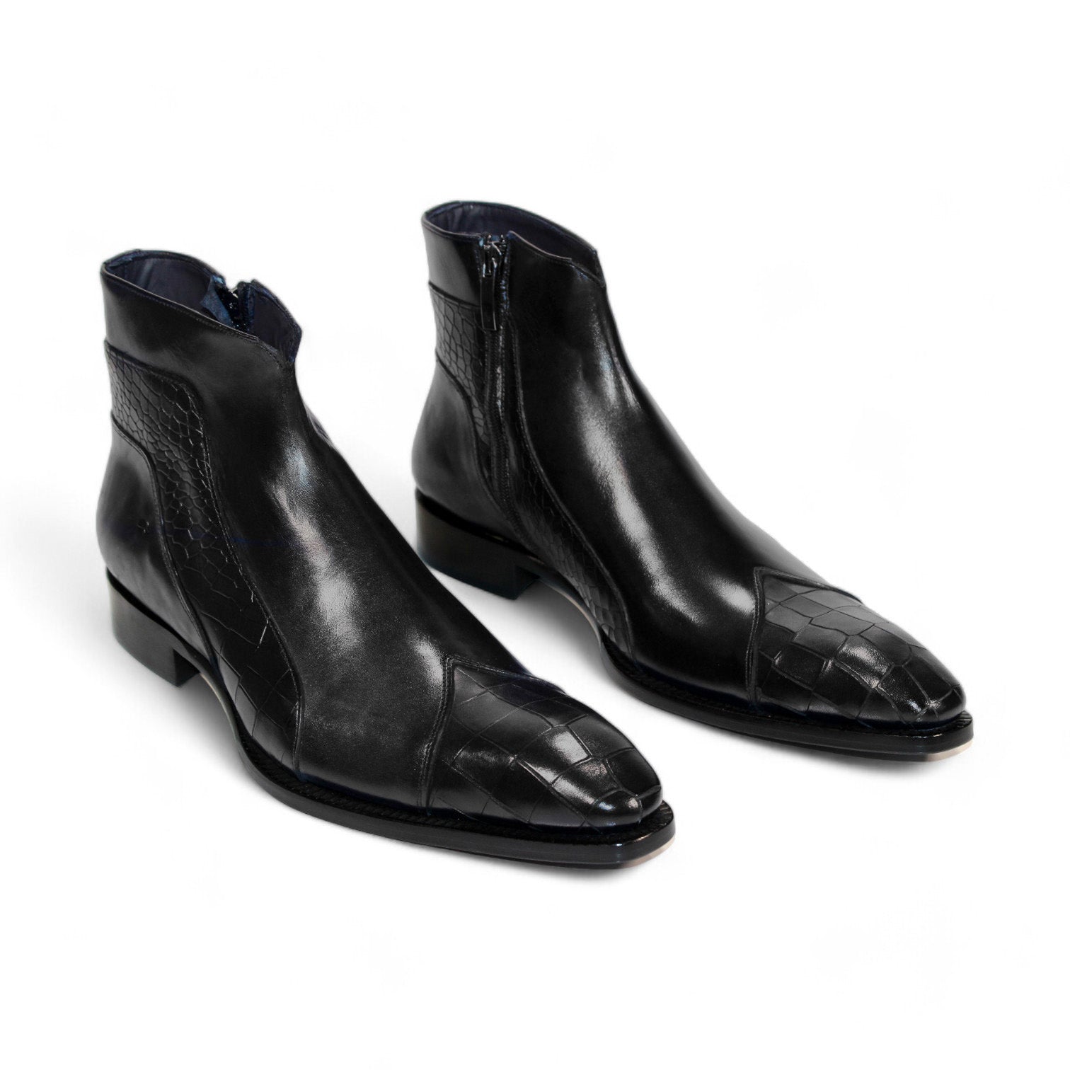 The Duca Di Matiste Aprilia (Black) ankle boot is skillfully crafted from genuine leather, showcasing a distinctive embossed Croco design on the toe and side. With its sleek finish and low heel, this Italian-made footwear embodies elegance.