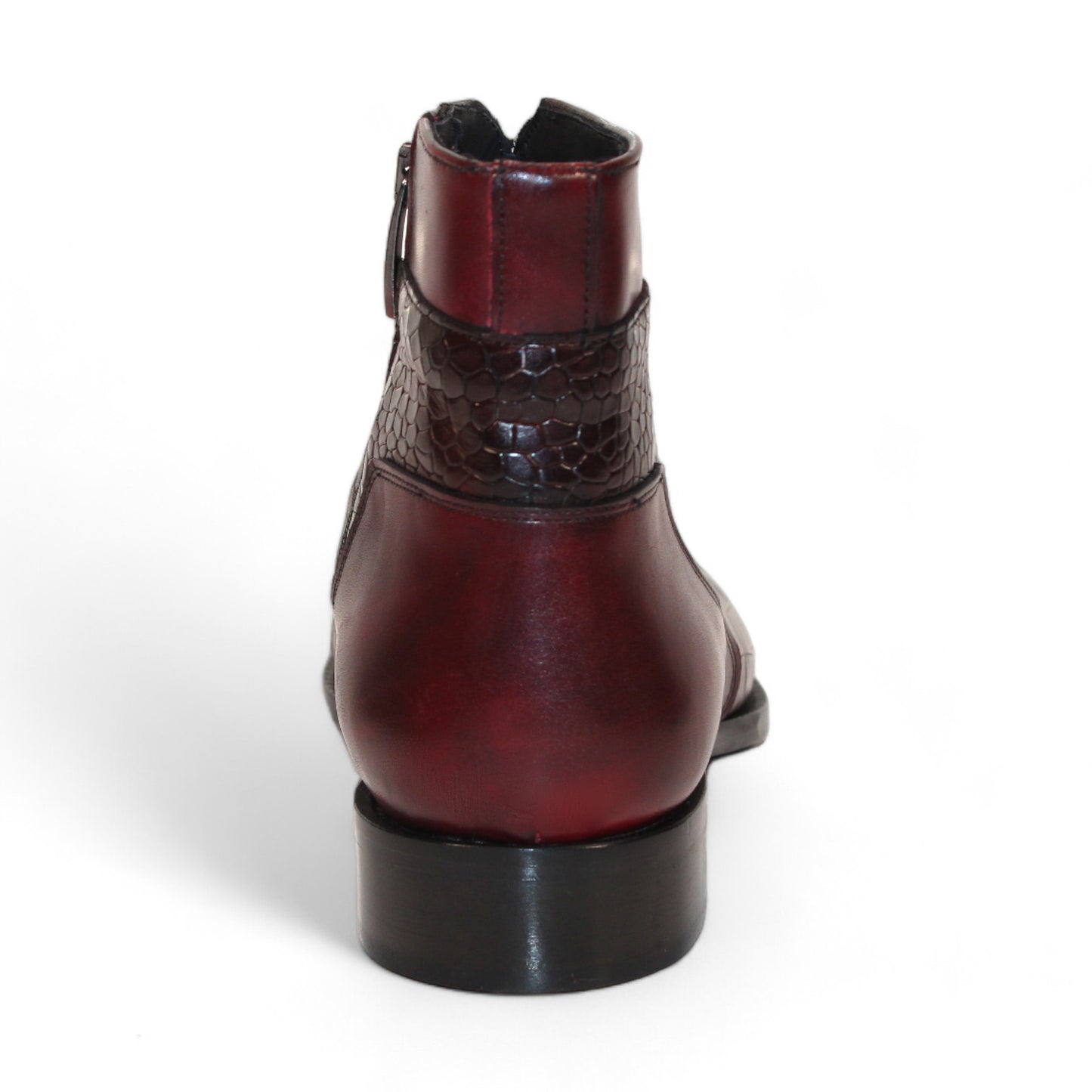 Displayed strikingly against a white background, the Duca Di Matiste Aprilia ankle boot in Burgundy/Antique Red features a luxurious Italian leather design with embossed croco pattern accents and a tasteful low heel.