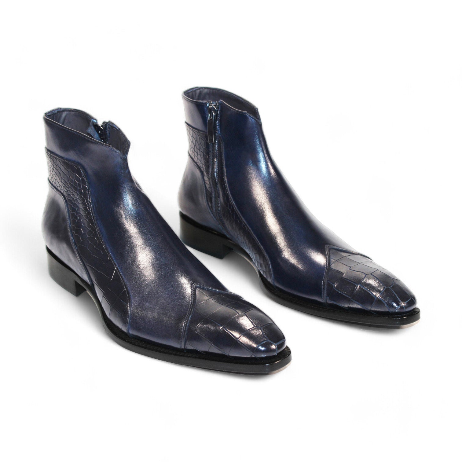 The Duca Di Matiste Aprilia (Navy), made in Italy, is a blue leather ankle boot featuring a striking crocodile pattern and square toe on a pristine white background.