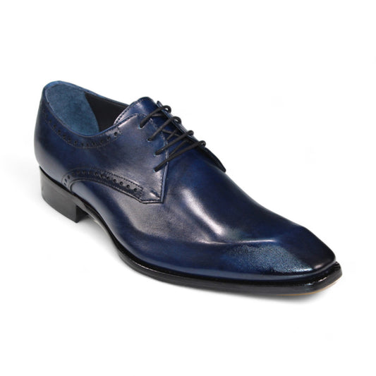 The Duca Di Matiste Arpino (Navy) is a dark blue leather dress shoe made in Italy, crafted from genuine leather, and showcasing decorative perforations with black laces against a pristine white background.