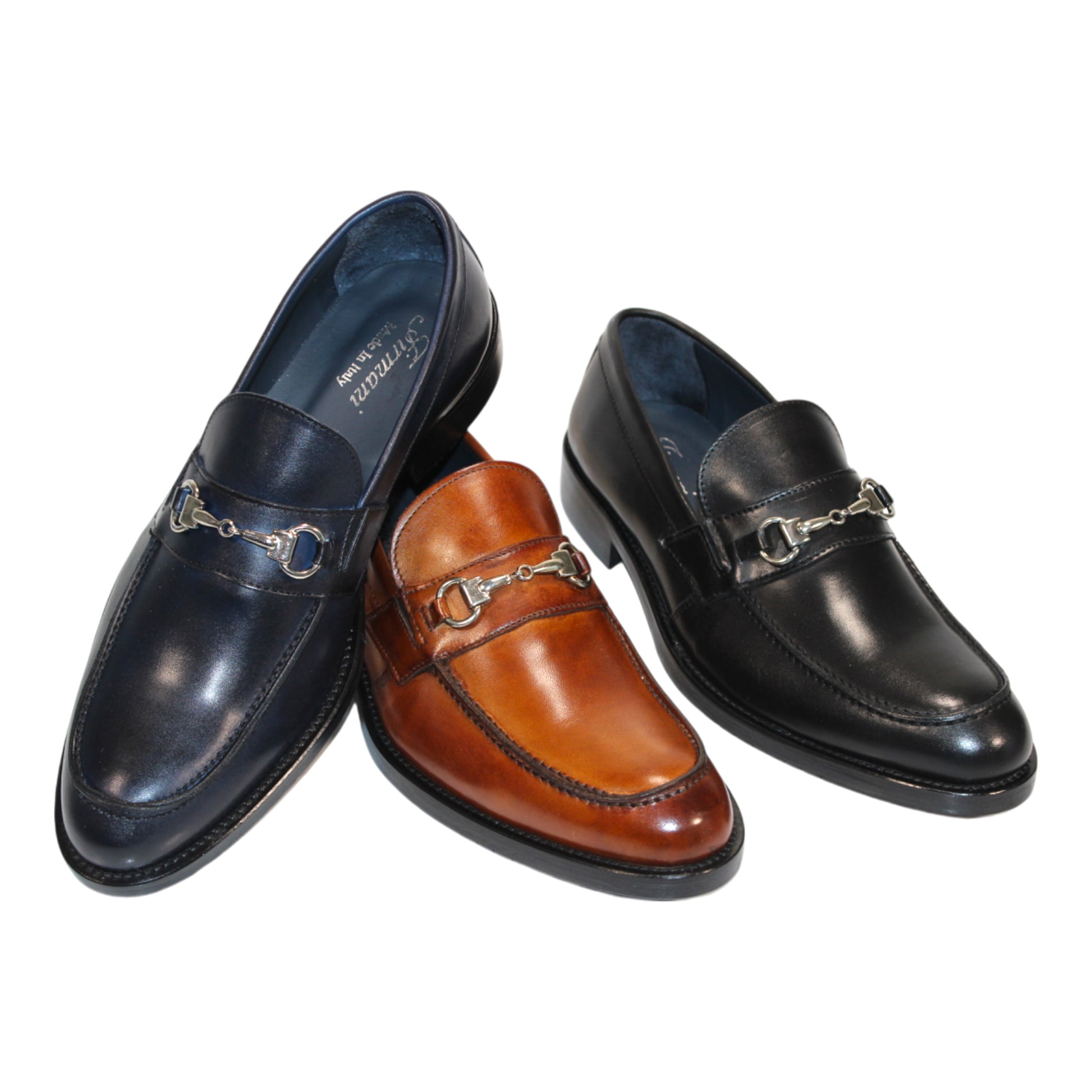 Firmani boasts a sophisticated selection with the Firmani Ben Cognac Shoes, crafted from fine leather and featuring a stylish metal buckle, available in classic dark blue, brown, and black.