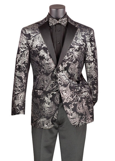 A mannequin showcases the Vinci Modern Fit Velvet Jacket Metallic Design Silver BM-02 by Vinci Suits, presenting a black suit with an eye-catching silver paisley pattern. This sophisticated ensemble is complemented by a black dress shirt, a patterned bow tie, and sleek black pants.