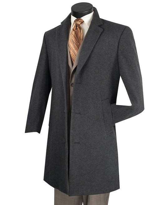 A Vinci Suits "Vinci Wool & Cashmere Regular Fit Top Coat 38" Long in Charcoal CL38" elegantly drapes over a beige suit and white shirt, perfectly complemented by a brown striped tie, all showcased on a mannequin against a simple backdrop.