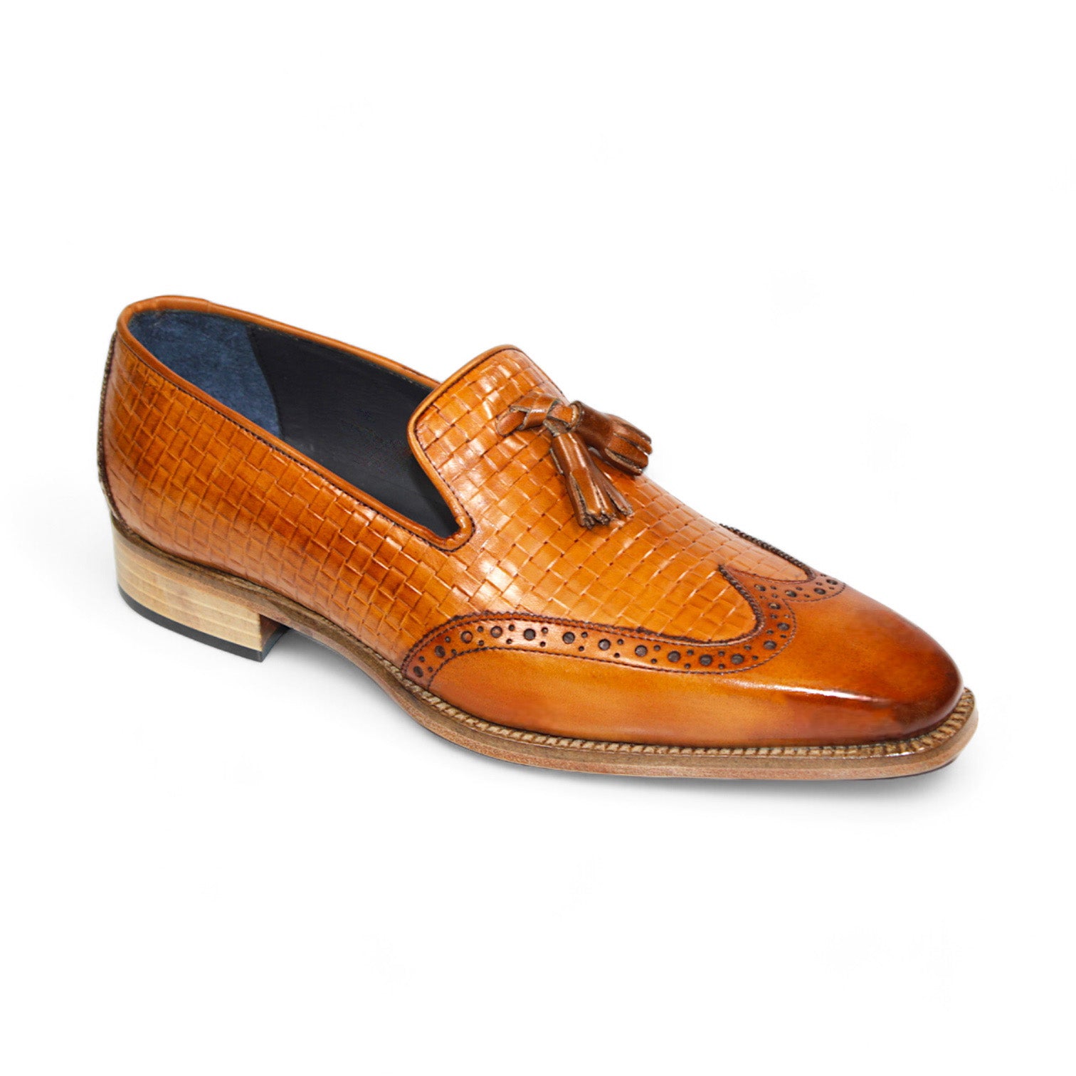 The Duca Di Matiste Cosenza (Cognac) loafer from Duca Di Matiste features Italian leather in a brown hue, a woven texture, front tassels, and a low stacked heel.