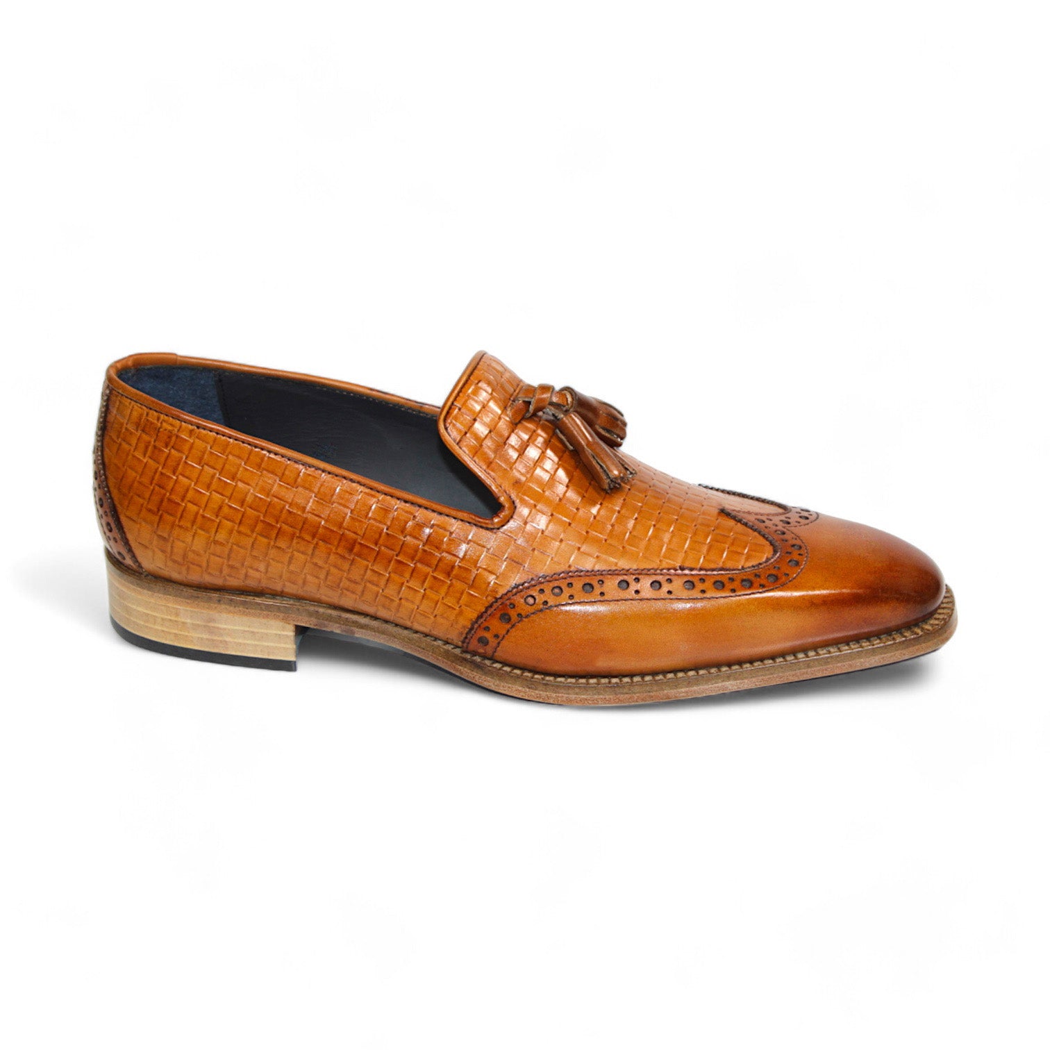 The Duca Di Matiste Cosenza (Cognac) loafer from Duca Di Matiste features Italian leather in a brown hue, a woven texture, front tassels, and a low stacked heel.